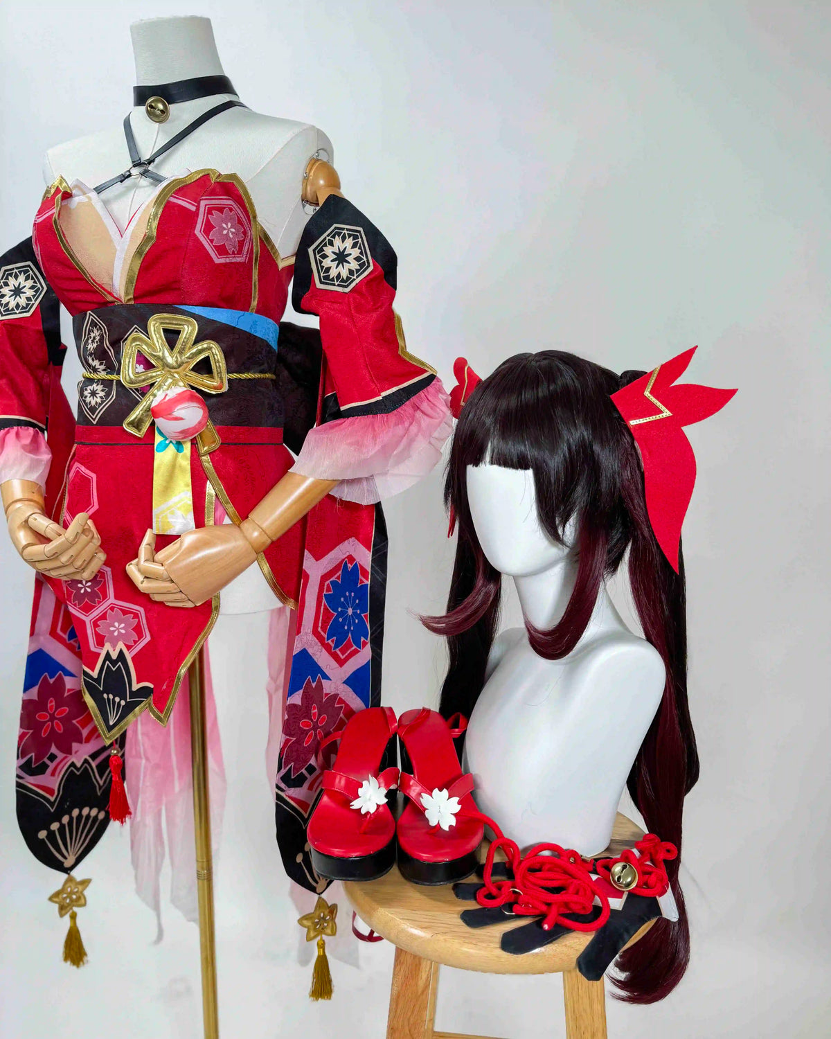 Angled view of the Sparkle cosplay outfit showing floral patterns, waist ornaments, a black wig and red accessories