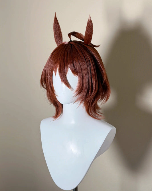 Angled view of the Agnes Tachyon cosplay wig showing long reddish-brown bangs and the horse ear accessories