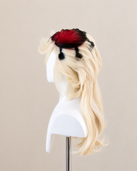 Side view of the Doma cosplay wig showing layered blond waves and red and black accents at the crown