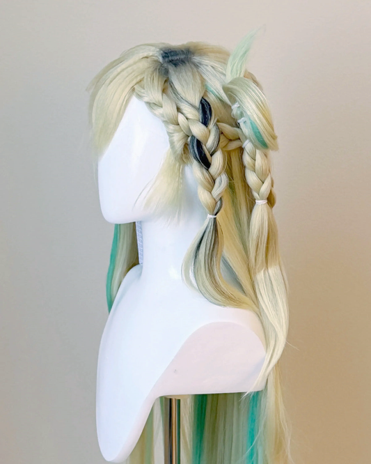 Side view of the Lynae cosplay wig showing a blond braid, sculpted loop and green strands through the long hair