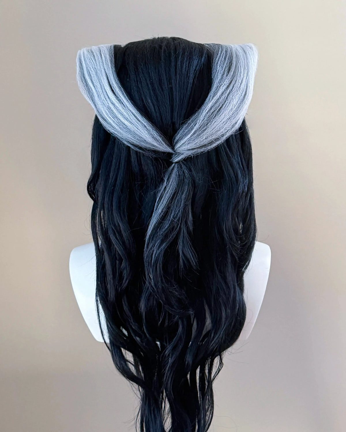 Back view of the Renata Glasc cosplay wig showing silver sections meeting above long black waves