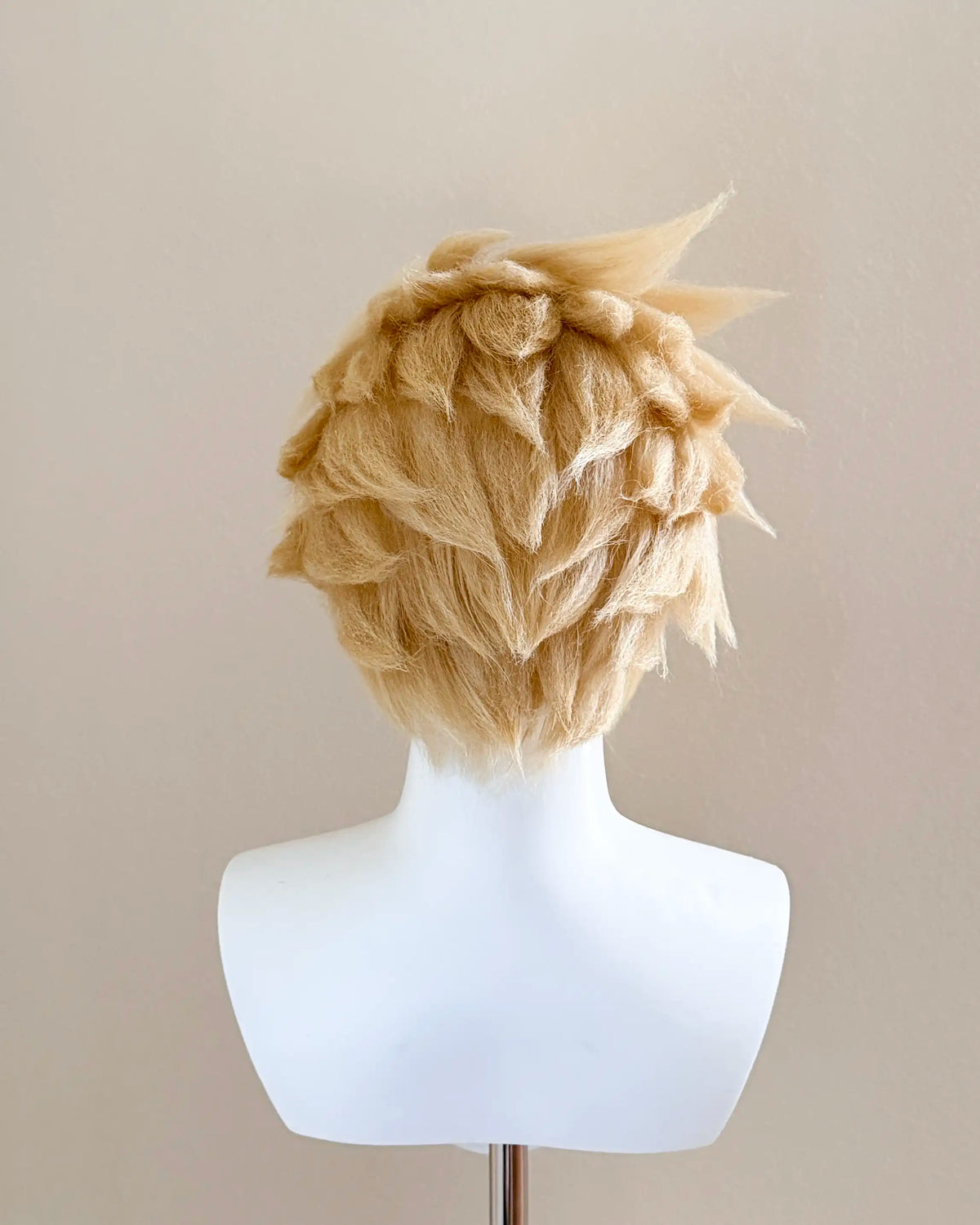 Back view of the Cloud Strife cosplay wig showing layered blond spikes and a tapered nape