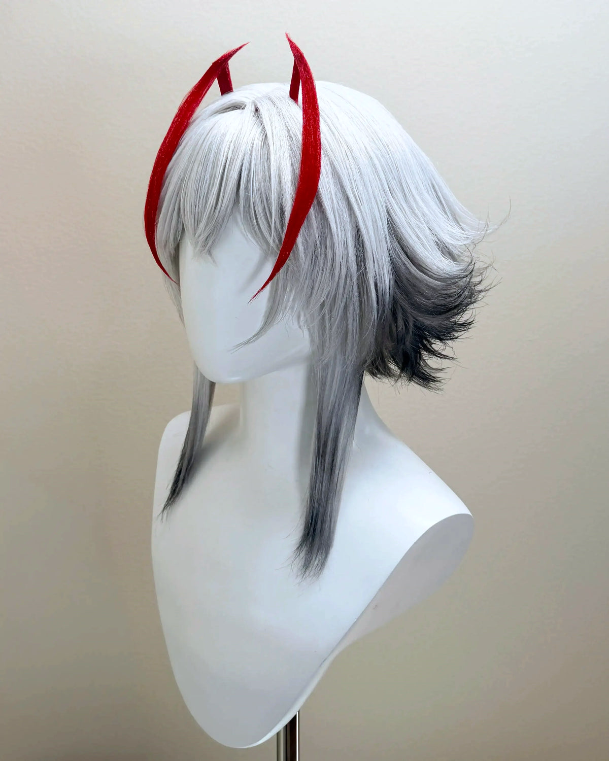 Three-quarter view of the silver-gray Arknights wig with red accents and feathered side layers